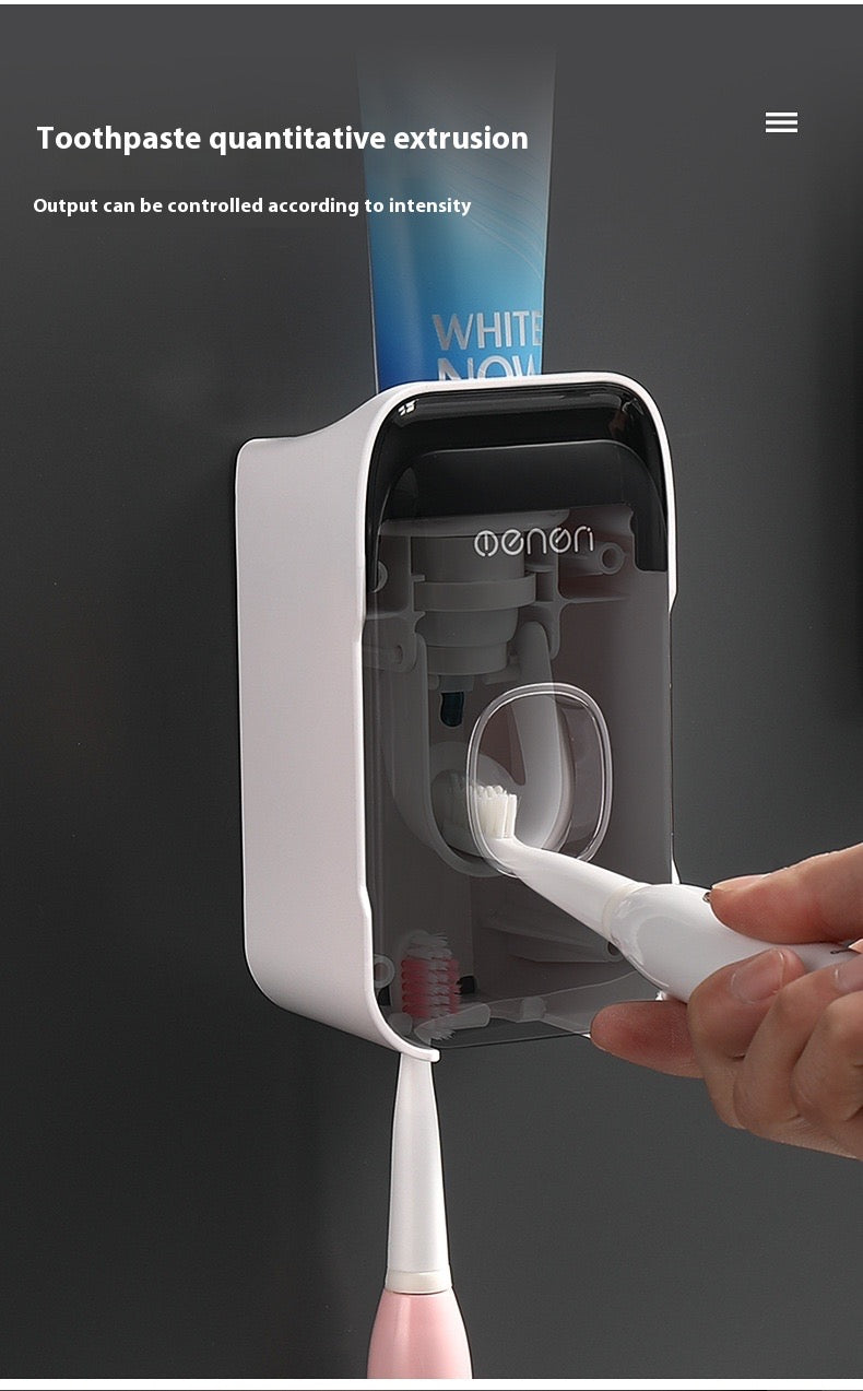 Automated toothpaste dispenser dispensing toothpaste into a brush held by a person.