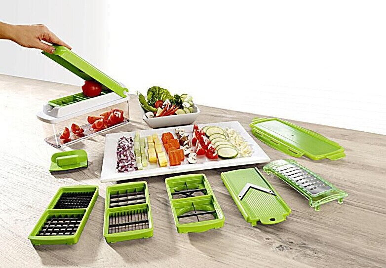 Green kitchen utensil set with various attachments on a wooden surface.