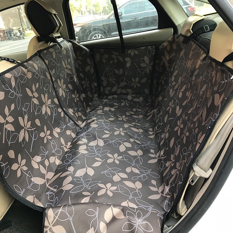 Floral-patterned car seat cover on a car's back seat