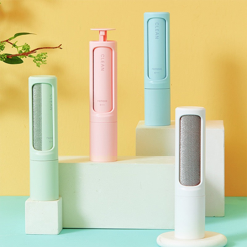 Four cylindrical cleaning tools in pastel colors on a geometric platform with a yellow and blue gradient background.