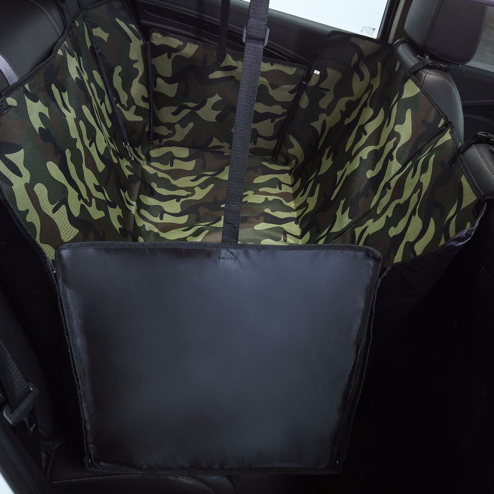 Camouflage-patterned car seat cover with a black storage pouch inside a vehicle.