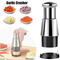 Garlic crusher with garlic, onion, and carrot samples on a white background