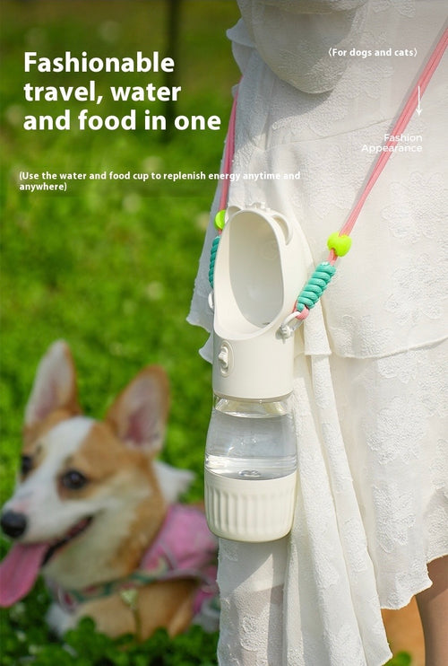 Portable water and food cup for pets with a dog in the background