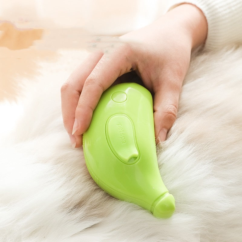 Green pet grooming tool being used on a fluffy white animal