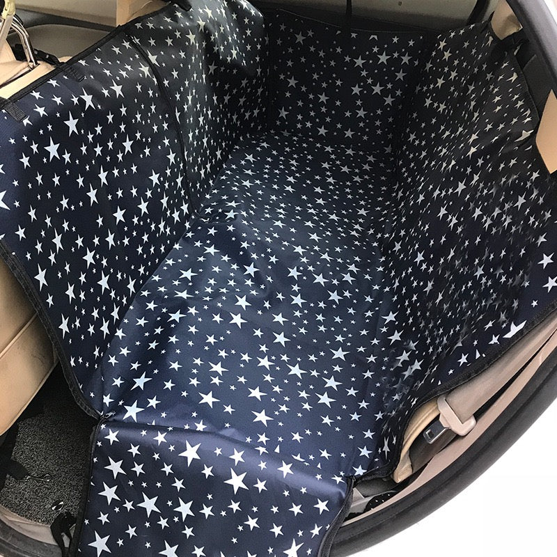 Navy blue car seat cover with white star pattern inside a vehicle.