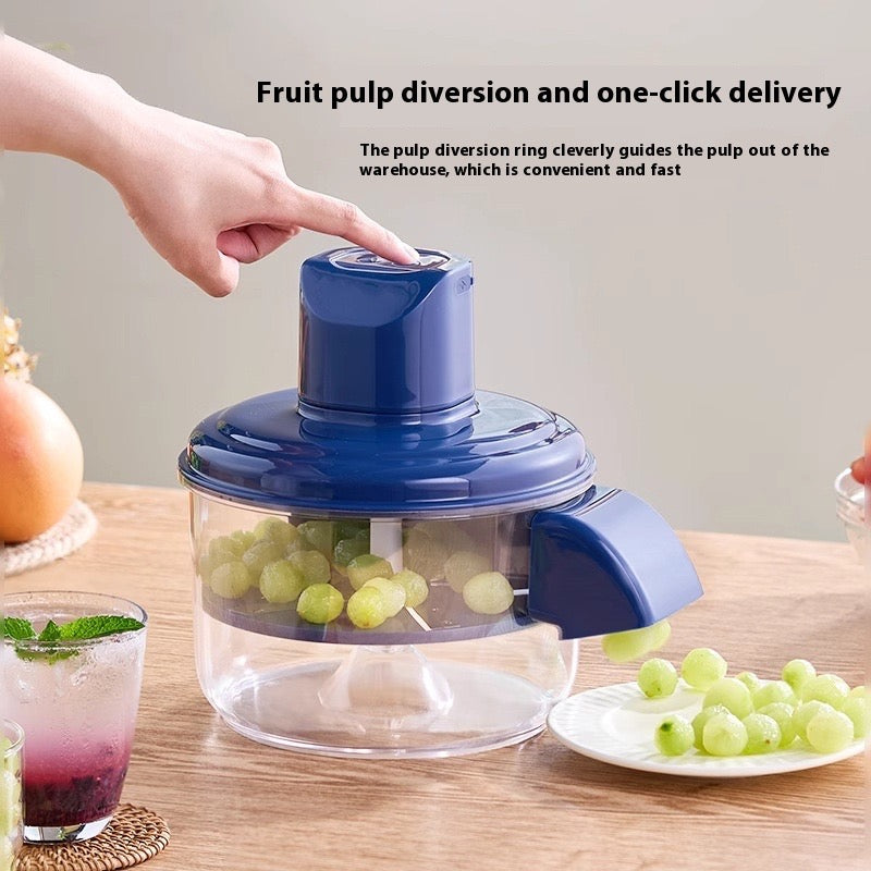 Fruit pulping device with grapes on a wooden table, showing pulp diversion ring feature.