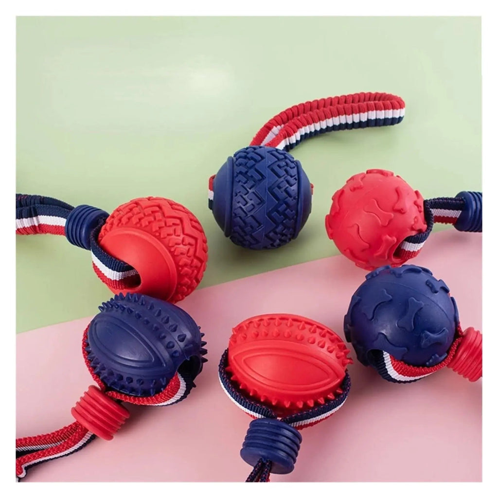 Red and blue dog toys with a rope on a pink and green background