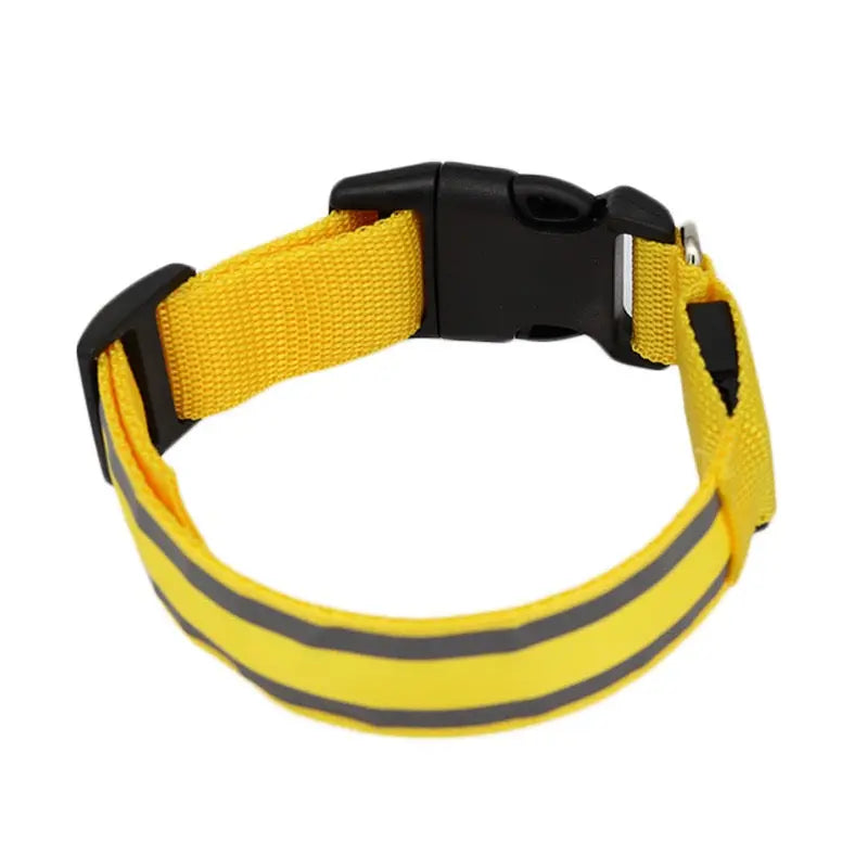 Yellow dog collar with reflective stripes on a white background