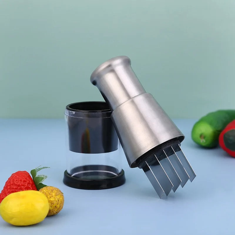 Metallic kitchen tool with a clear container on a light blue background with fruits and vegetables.