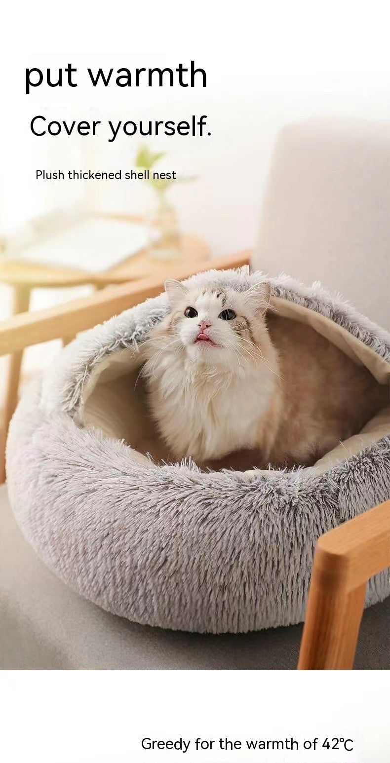 Cat in a plush shell pet bed with text about warmth and comfort.